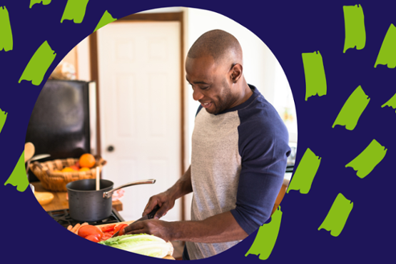 A man cutting vegetables in the kitchen