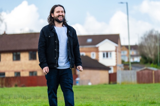 A man on a walk smiling